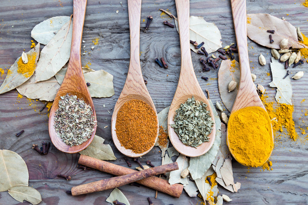 Spices in spoons on wooden table - Photo, Image