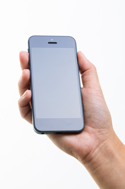 Vrouwelijke hand met een slimme telefoon, geïsoleerd op wit - Foto, afbeelding
