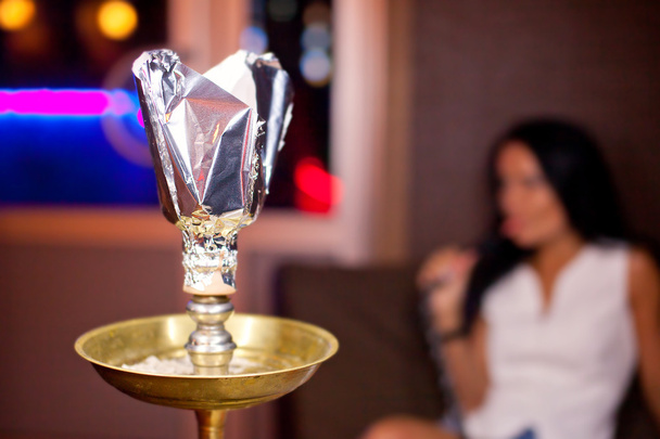 Close-up photo of hookah with smoking girl on background - Foto, Bild