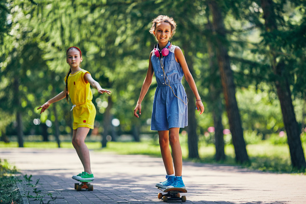 girl and her friend skateboarding - Photo, Image