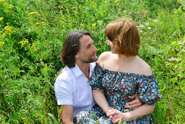 loving couple sitting on the grass in  summer - Φωτογραφία, εικόνα
