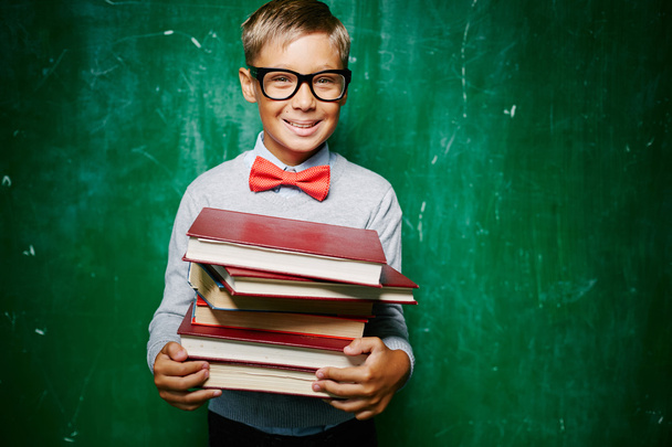 boy with stack of books - Photo, Image