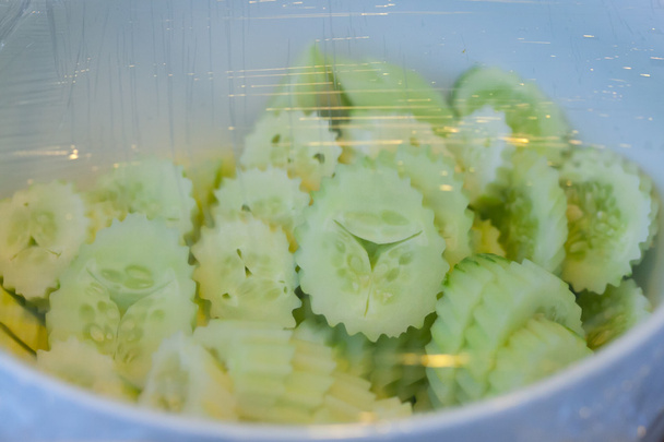 Vegetables in a glass bowl on the plastic wrap. - 写真・画像