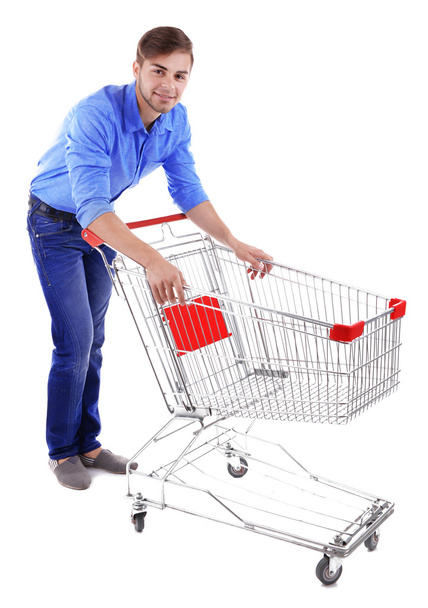 Young man with empty shopping cart - Valokuva, kuva