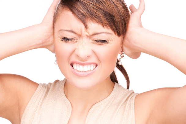 Unhappy woman with hands on ears - 写真・画像