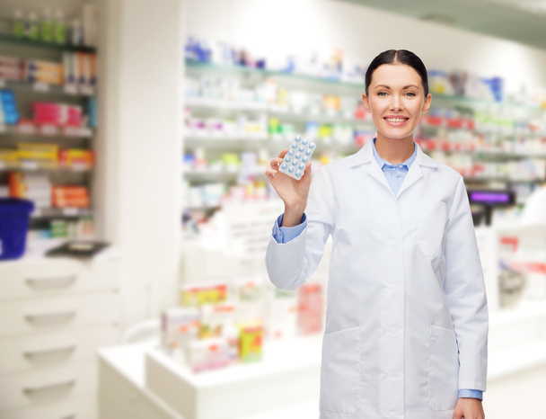 woman pharmacist with pills drugstore or pharmacy - Фото, изображение