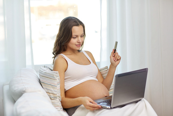 pregnant woman with laptop and ultrasound image - Fotó, kép