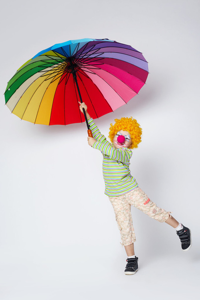 clown with colorful umbrella on white - Фото, изображение
