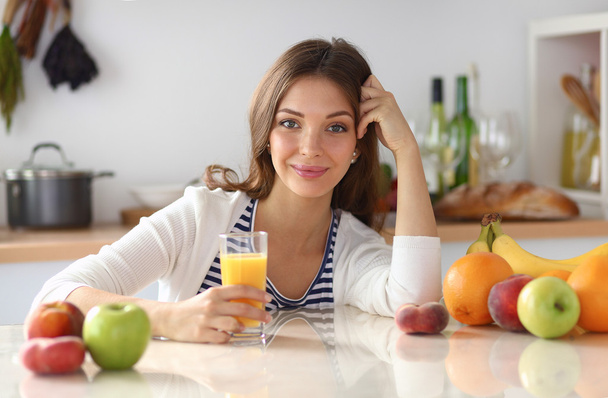 Portrait of a pretty woman holding glass with tasty juice - Zdjęcie, obraz