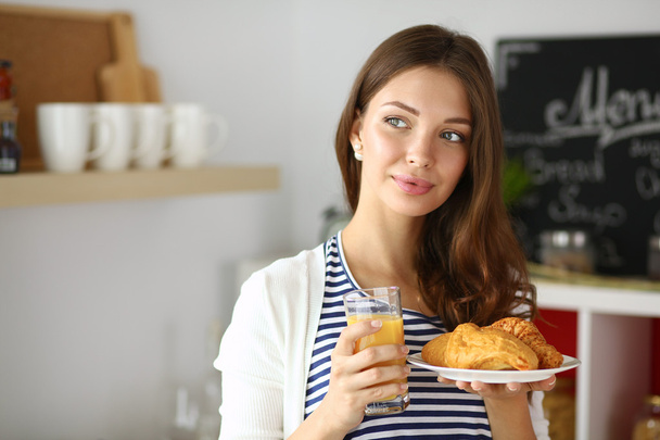 Young woman with glass of juice and cakes - Valokuva, kuva