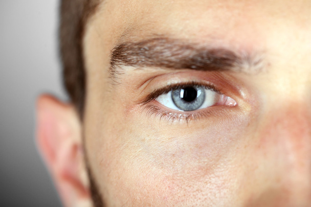 Beautiful blue man eye close up - Foto, afbeelding