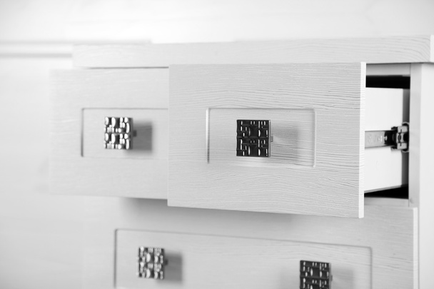 White wooden chest of drawer, close up. Open drawer - Fotó, kép