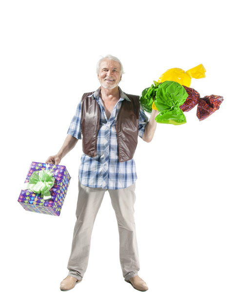 hombre mayor con caramelos y bolsa de regalo
 - Foto, Imagen