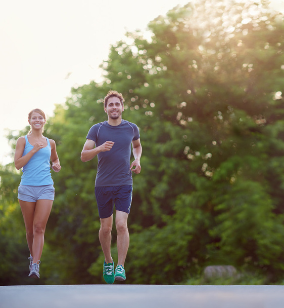 couple running together in park - Photo, Image