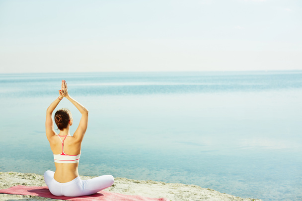 femme faisant de l'exercice de yoga sur la plage
 - Photo, image