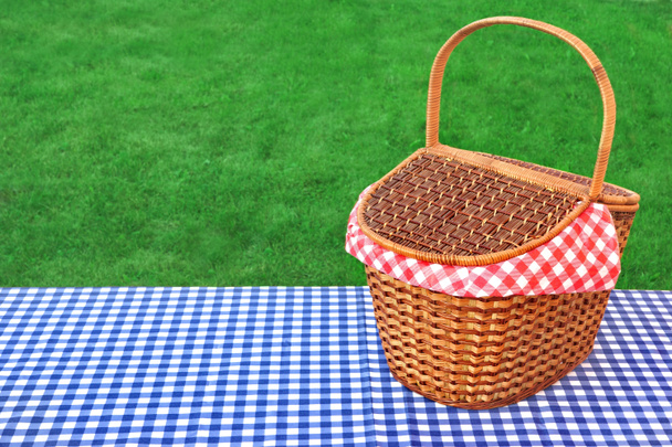 Outdoor Rustic Picnic Table With Hamper And Blue Tablecloth - Photo, Image