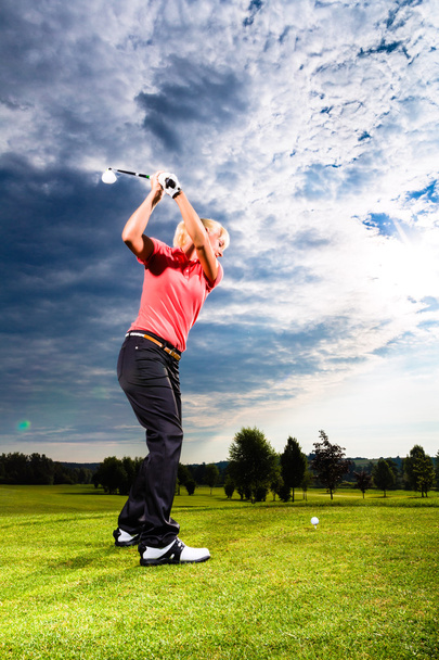 Giovane giocatore di golf in campo facendo swing golf
 - Foto, immagini