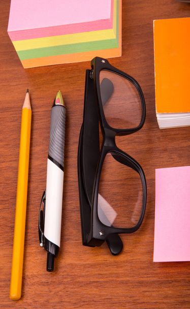 Office desk with glasses pen pencil ruler and other office items - Фото, зображення