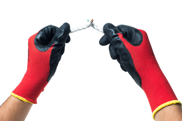 Constructor hands in red rubber gloves fixind the wire. isolated - Fotografie, Obrázek