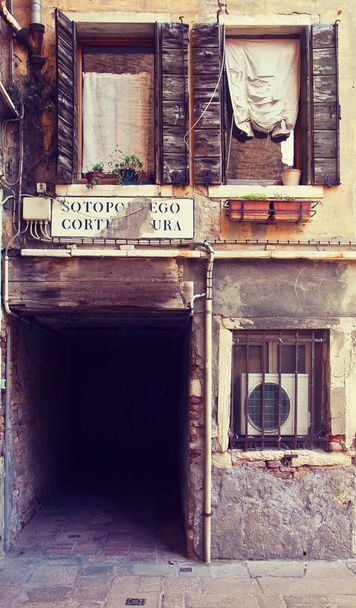 Venice, Italy - picturesque corner with dark pedestrian passage  - Photo, Image