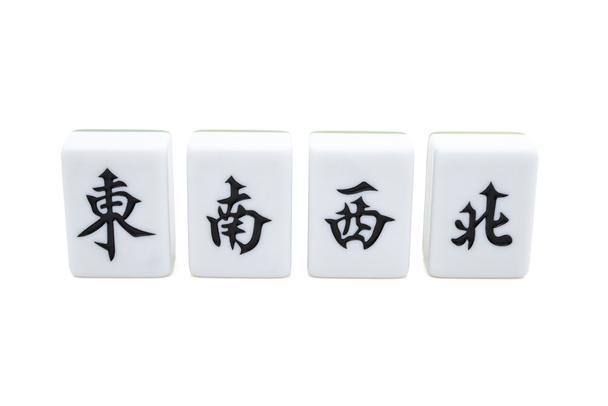 Mah jong bricks on white with clipping path, the Chinese on the bricks from left to right menas east, south, west, north, they refer to different directions of the wind - Photo, Image
