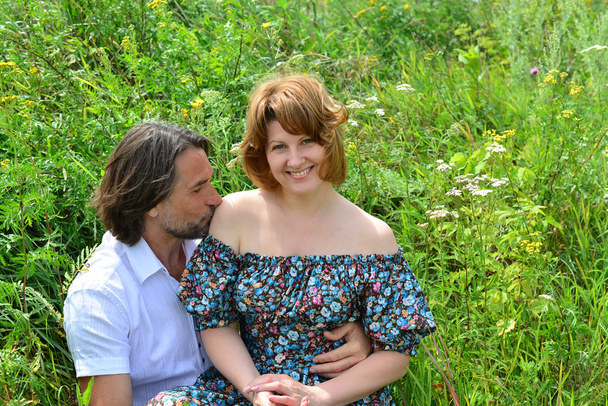 loving couple sitting on the grass in  summer - Foto, Imagem