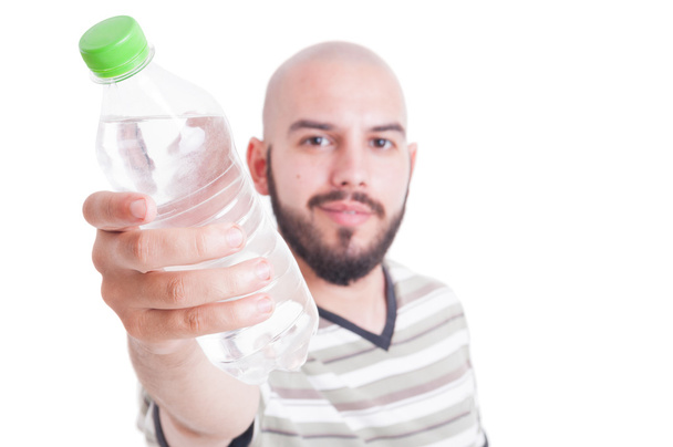 Man offering a plastic bottle of cold water - Foto, Bild
