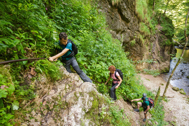 hikers holding on to a safety cable - 写真・画像