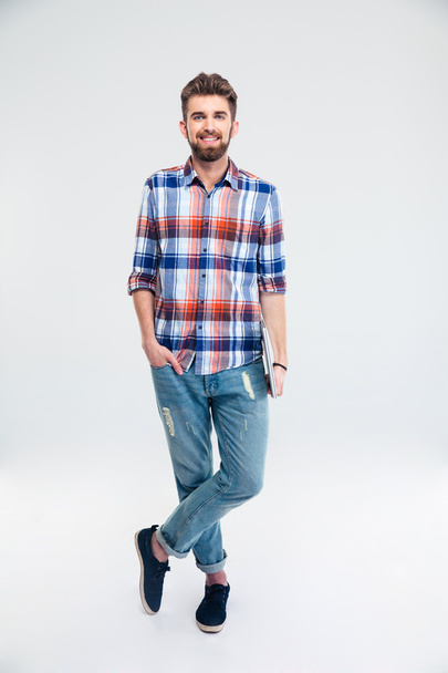Full length portrait of a man standing with laptop - Photo, Image