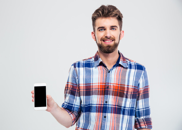Hombre mostrando pantalla de teléfono inteligente en blanco
 - Foto, imagen