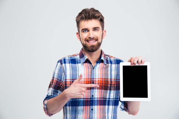 Man pointing finger on blank tablet computer screen is - Фото, изображение
