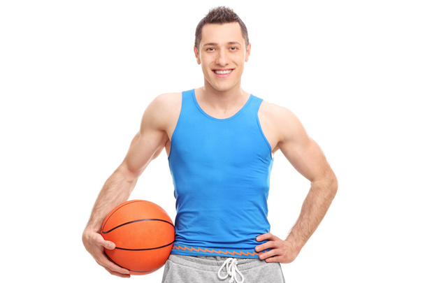 Young athlete holding a basketball - Foto, immagini