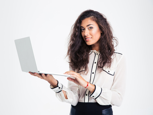 Happy businesswoman standing with laptop  - Valokuva, kuva