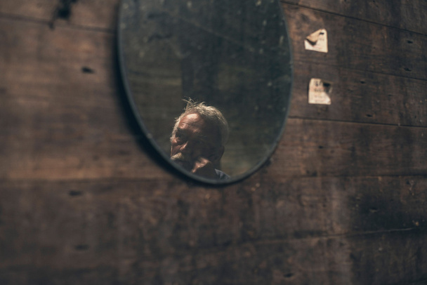 Reflection of elderly man in mirror - Photo, Image