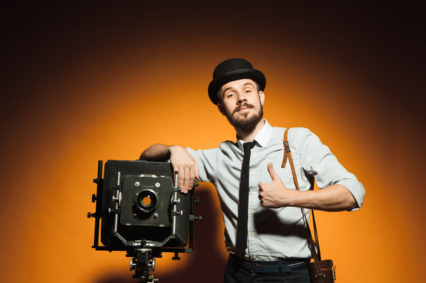 young man with retro camera  - Zdjęcie, obraz