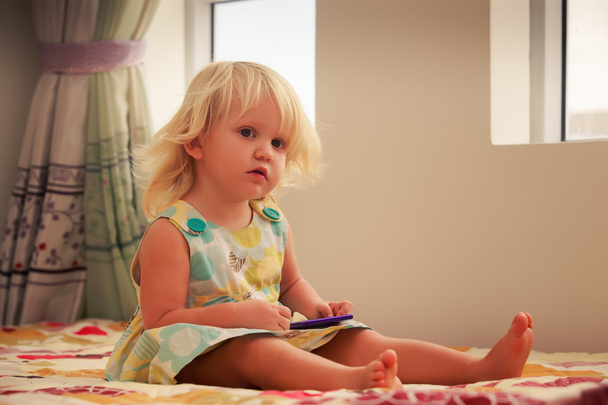 little girl plays with smartphone - Fotografie, Obrázek