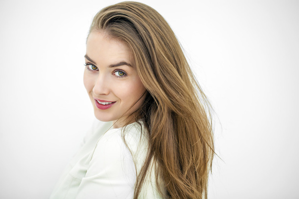 Beautiful young happy woman posing against a white wall - Foto, immagini