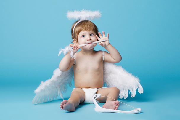 little angel on blue background - Foto, Imagem