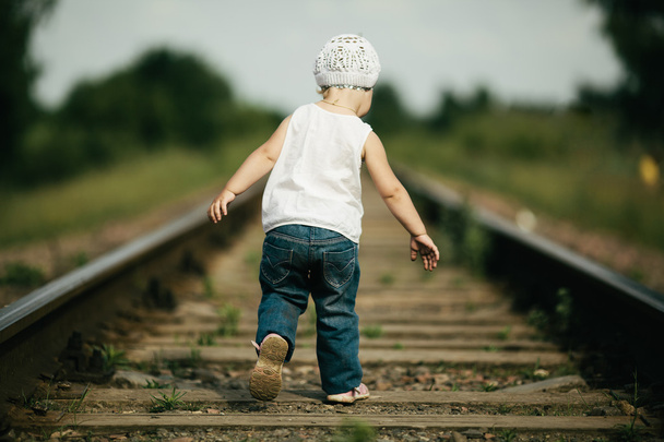 little girl plays on railroad - Фото, изображение