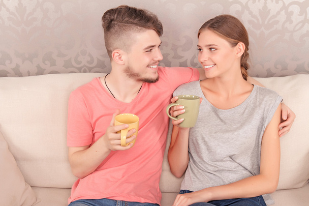 Lively young couple drinking tea  - Foto, imagen