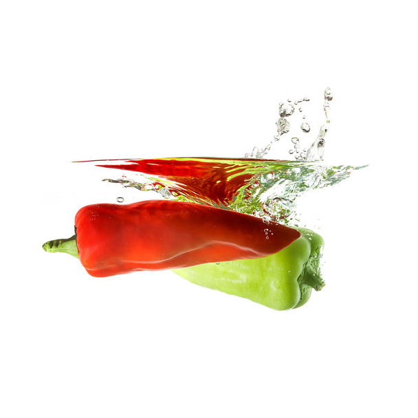 Peppers splash on water, isolated on white background - Foto, Bild
