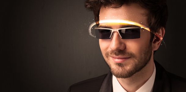 Handsome man looking with futuristic high tech glasses  - Фото, изображение