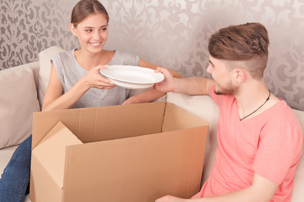 Nice couple opening boxes  - 写真・画像
