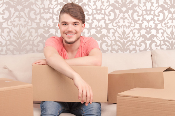 Pleased young husband holding box - Foto, imagen