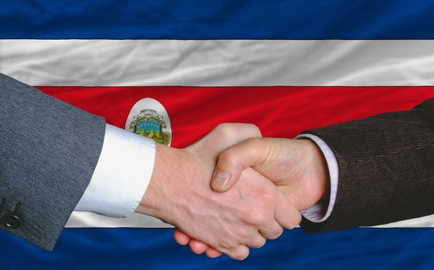business men handshakafterwards good deal in front of costarica flag
 - Фото, изображение