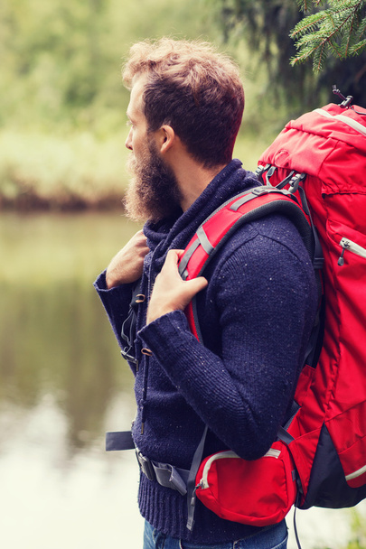 smiling man with beard and backpack hiking - Foto, afbeelding