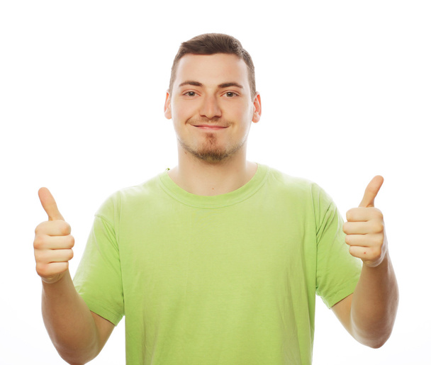 young man in green shirt  showing thumbs up.  - Foto, Bild
