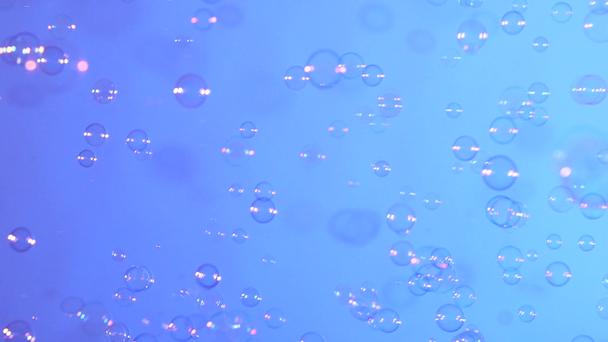 Soap bubbles on blue, background, slow motion - Footage, Video