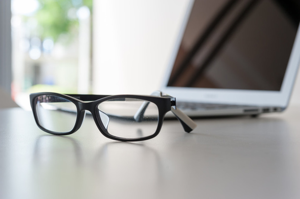 close up glasses on work desk with laptop - Foto, imagen