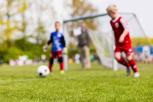 Blurred kids playing youth football match - Foto, Imagen